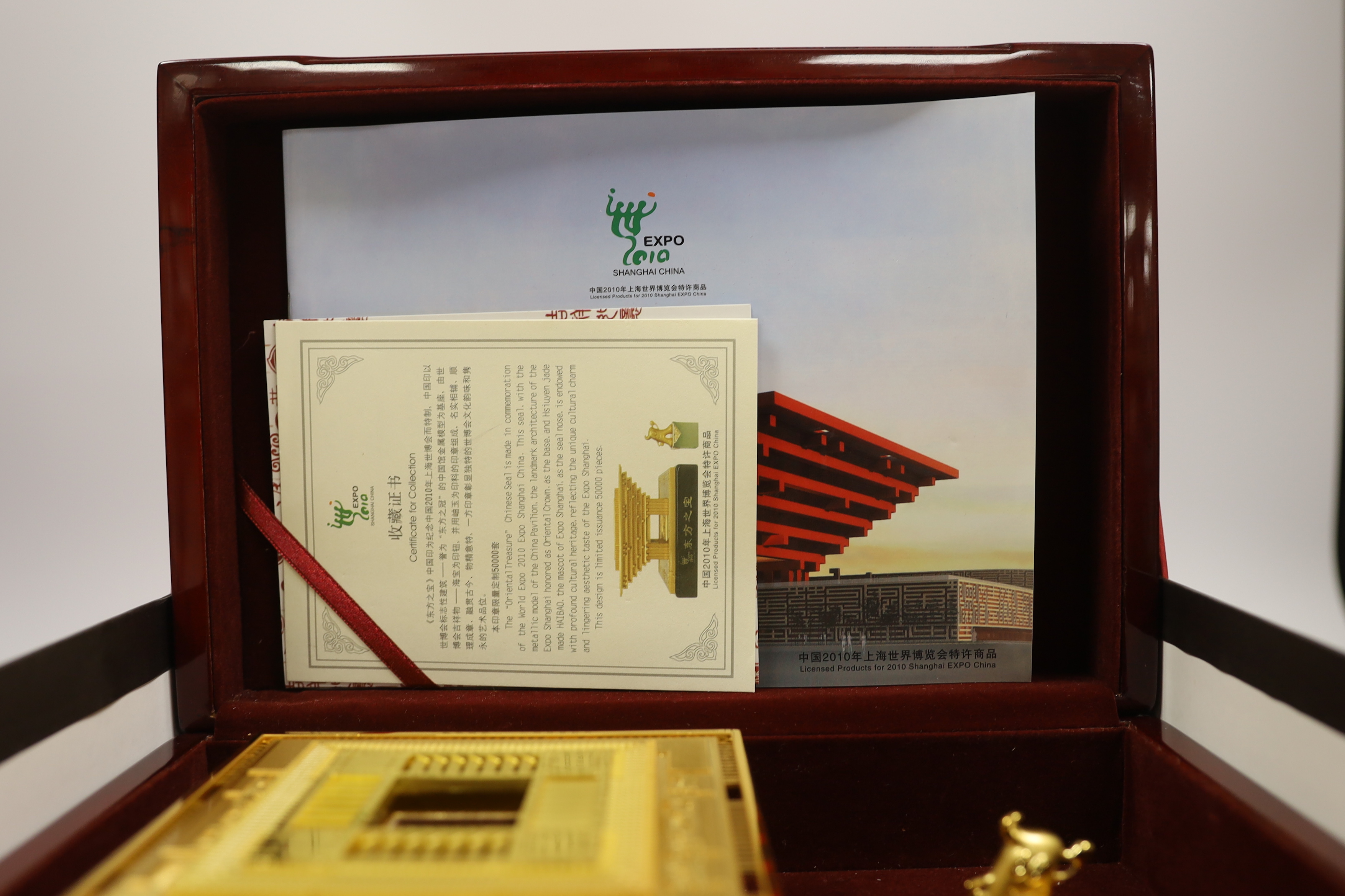 A cased Chinese Shanghai Expo 2010 model in gilt metal, 10cm high